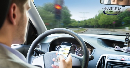Man behind the wheel texting while driving.